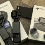 DJI Osmo Pocket 4K gimbal stabilizer with handheld module and accessories on a wooden floor surface
