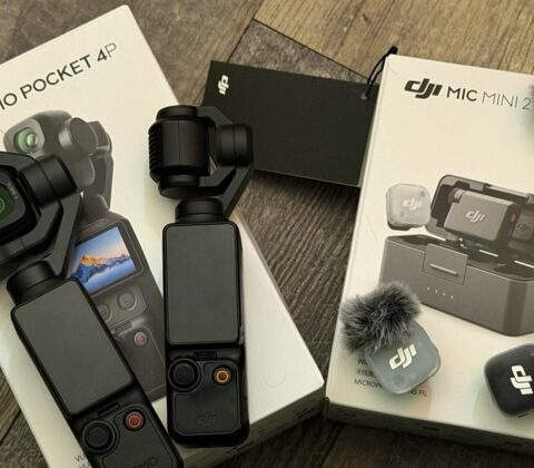 DJI Osmo Pocket 4K gimbal stabilizer with handheld module and accessories on a wooden floor surface