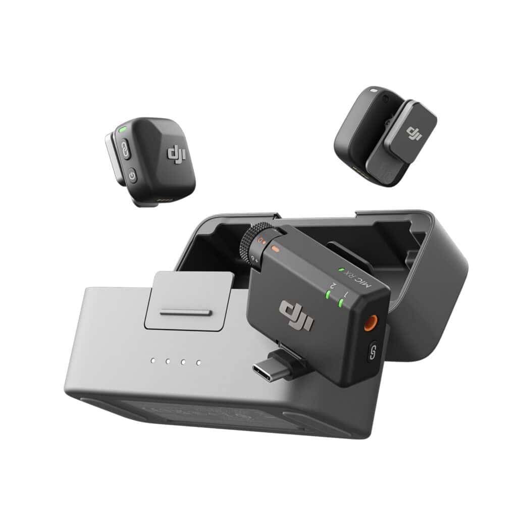 Close-up of DJI accessories: two small black modular adapters and a charging dock with the DJI logo visible.
