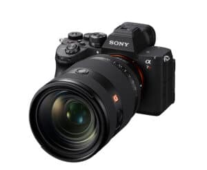 Sony α7R mirrorless camera with a large attached zoom lens, angled from the front-left.