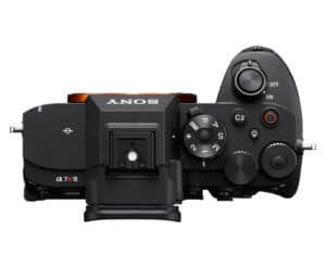Top-right profile view of a Sony α7R IV mirrorless camera body with mode dial, shutter button, and control dials on a white background