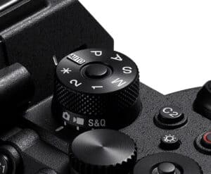 Close-up of a camera's top with the mode dial showing P, A, S, M, Auto, and S&Q settings.