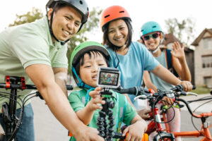 Family on a bikeride recording a video