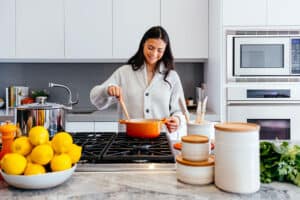 Lady cooking in kitchen at home