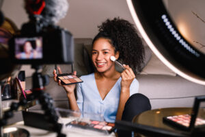 Girl shooting a makeup vlog with mirrorless and lighting