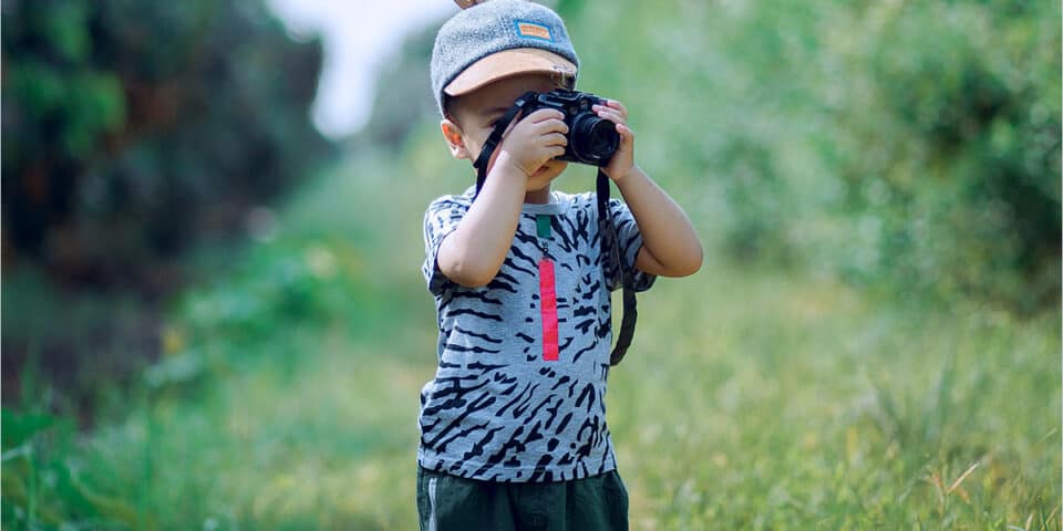 boy taking a photograph in the outdoors