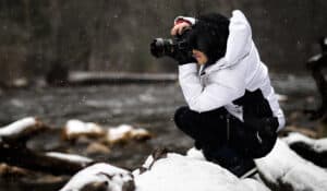 Girl Photographing Outside while Snowing