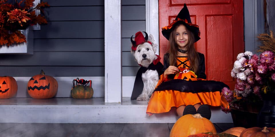 Girl and dog dressed up for halloween