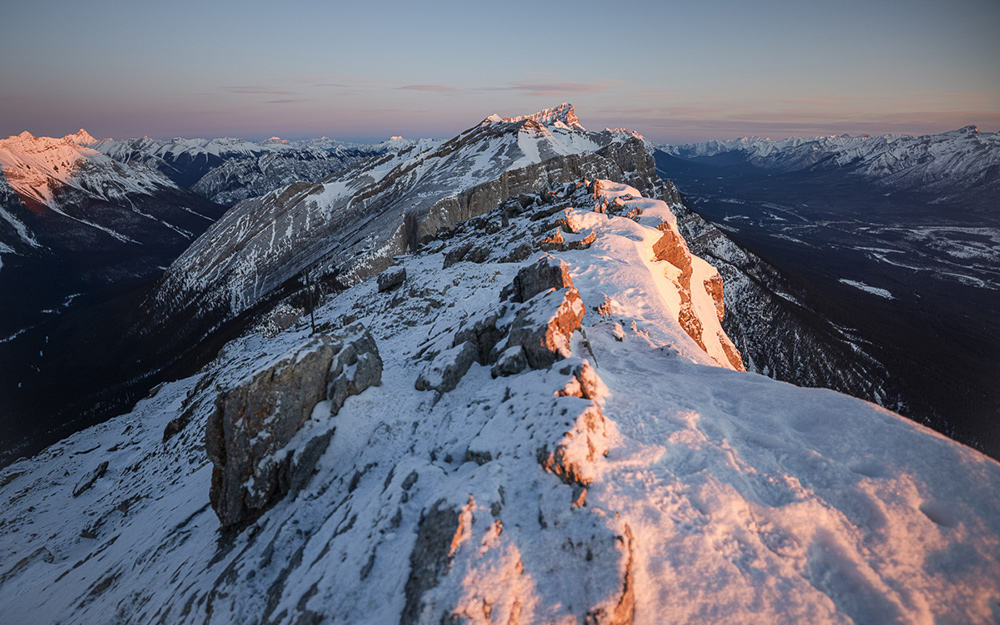 Alpenglow lighting up a mountain ridgeline.