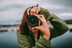 Female holding camera taking a photograph