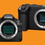 Two Canon mirrorless cameras without lenses on an orange background, showcasing front lenses and grips.