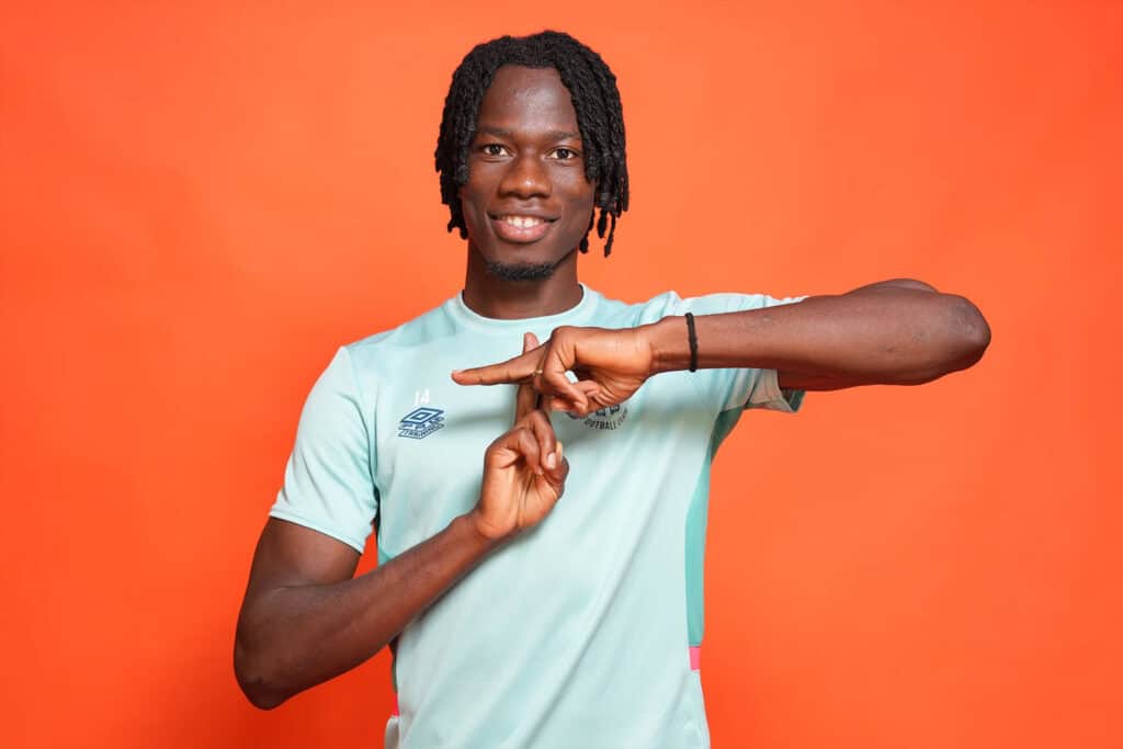 In a new player signing photo, Issa Kabore, on loan from Manchester City, shows his enthusiasm to be playing for Luton Town. This image was shot with the Sony 24-70mm f/2.8 G Master II lens at 40mm with one off camera flash in a soft box. Photo by David Horn. Sony Alpha 1. Sony 24-70mm f/2.8 G Master II. 1/160-sec., f/4, ISO 400
