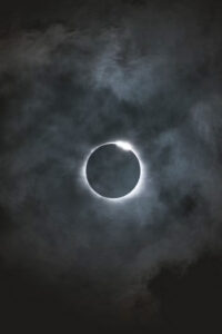 Solar eclipse: the Moon covers the Sun, revealing the Sun's corona around the dark disk.