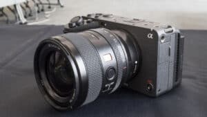 Sony Alpha mirrorless camera with a large zoom lens on a black surface